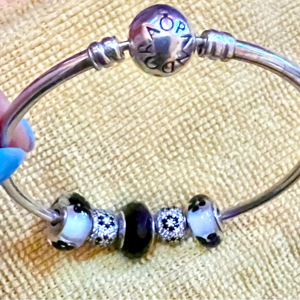Pandora 7 1/4 inch bangle bracelet with 5 Pandora charms (black, white,silver)